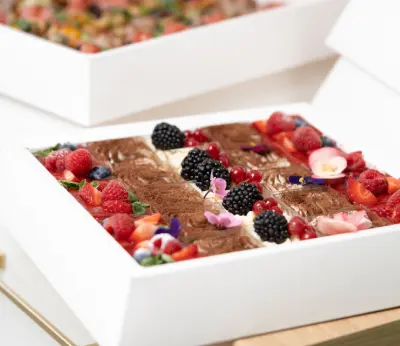 Dessert box with berries and chocolate-dusted cream