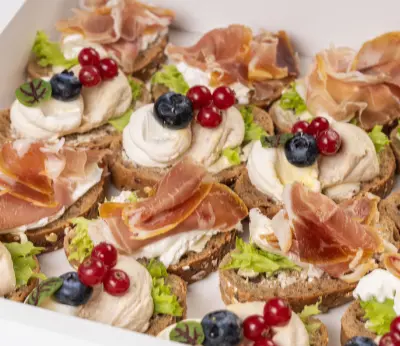Gourmet canapés with cured meats and berries